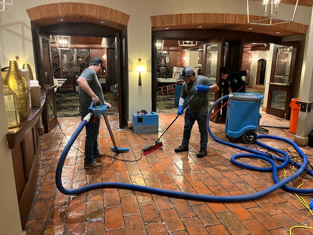 Rush Plumbing men with water vacumms after fixing faucet