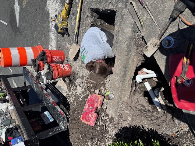 man digging in hole to prepare for reparing plumbing